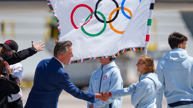 California Gov. Gavin Newsom, left, welcomes Team USA athletes arriving...