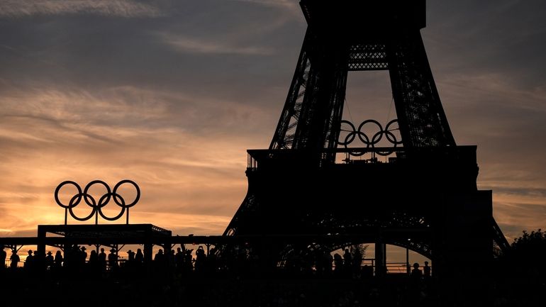 Spectators watch a quarterfinal beach volleyball match between Australia and...