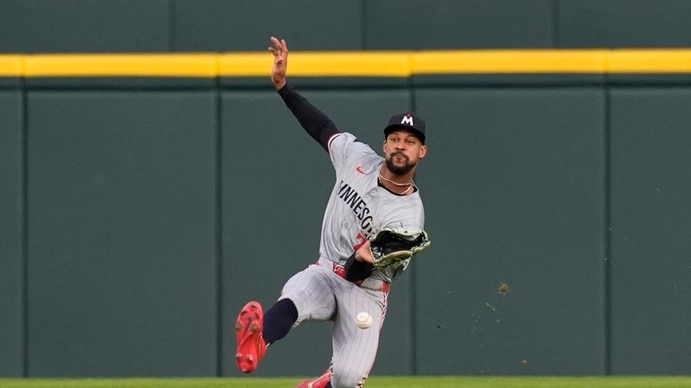 Minnesota Twins center fielder Byron Buxton misplays the double hit...