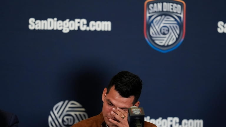 Hirving "Chucky" Lozano wipes tears from his eyes during an...