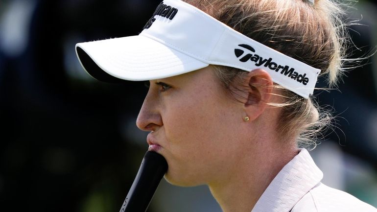 Nelly Korda measures her putt on the second green during...