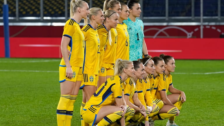 Sweden's players pose for a team photo ahead of the...