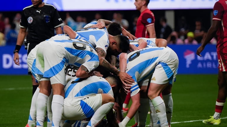 Argentina's Julian Alvarez, not seen, celebrates with teammates scoring the...