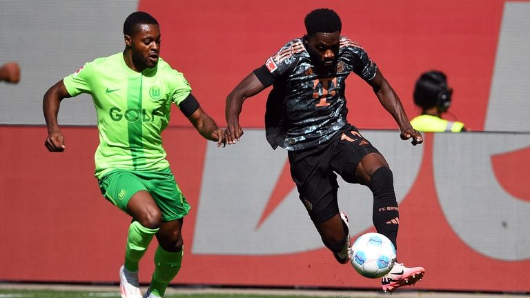 Wolfsburg's Ridle Baku, left, in action against Bayern's Alphonso Davies...