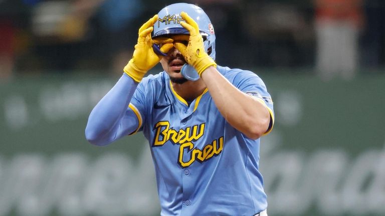 Milwaukee Brewers' Willy Adames reacts after hitting a double during...