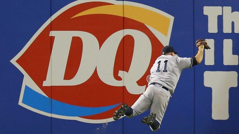 Brett Gardner makes a diving catch against the Texas Rangers...