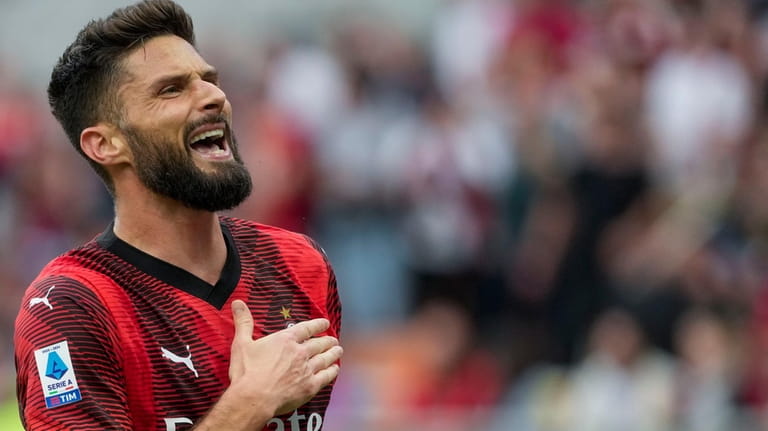 AC Milan's Olivier Giroud celebrates after scoring his side's third...