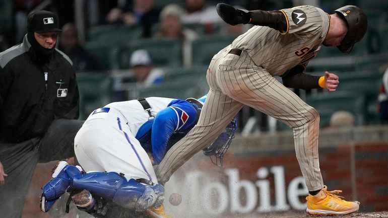 San Diego Padres' Jake Cronenworth, right, scores on a Rougned...