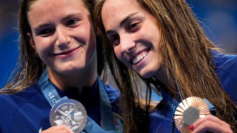 Silver medalist, Katie Grimes, left, of the United States, left,...