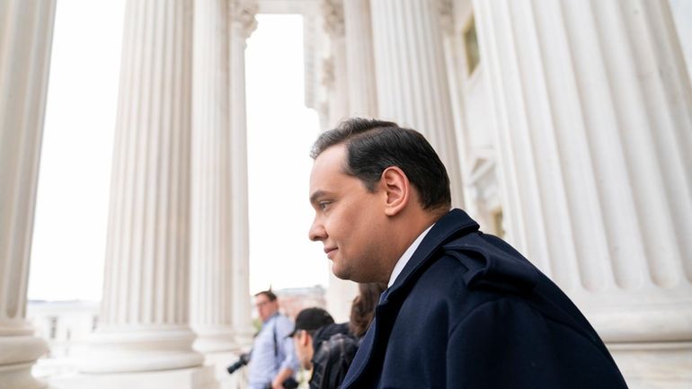 Rep. George Santos, R-N.Y., leaves the Capitol after being expelled...