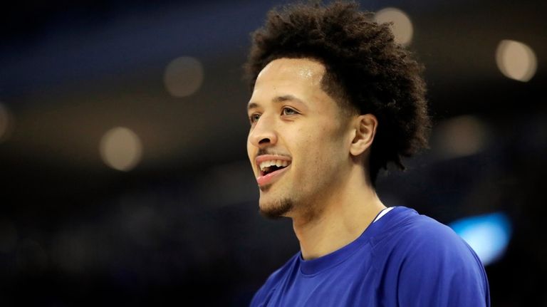 Detroit Pistons' Cade Cunningham smiles before an NBA basketball game...