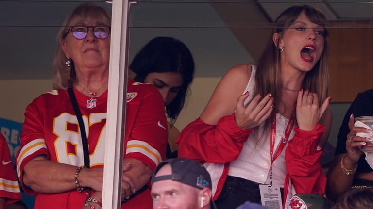 Taylor Swift, right, watches from a suite alongside Travis Kelce's...
