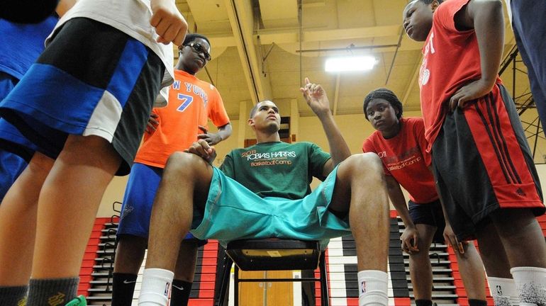 Tobias Harris, NBA player for the Milwaukee Bucks, talks to...