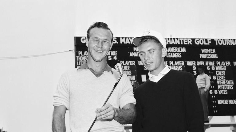 Arnold Palmer, left, 24, of Cleveland, Ohio, holds a 2-iron...