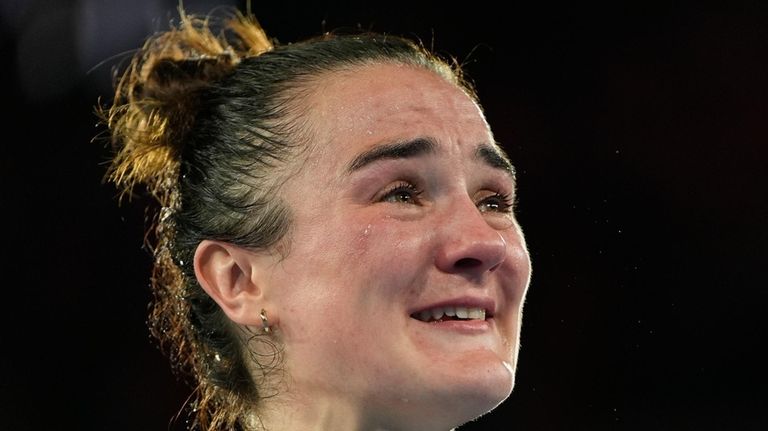 Gold medalist Ireland's Kellie Harrington reacts during the medals ceremony...