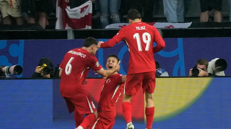 Turkey's Arda Guler celebrates after scoring his side's second goal...