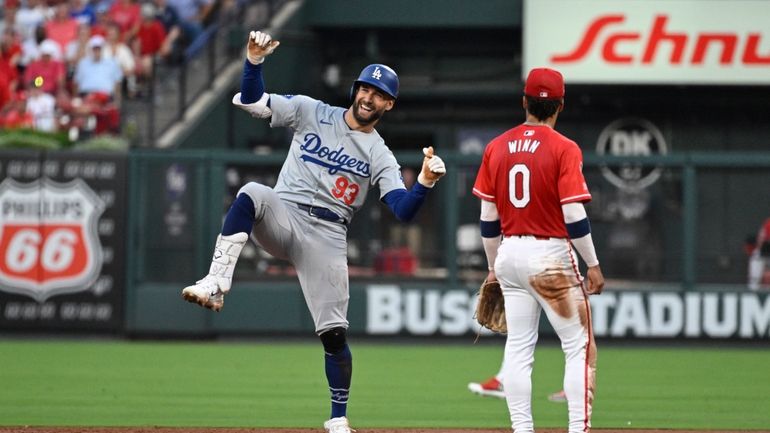 Los Angeles Dodgers' Kevin Kiermaier (93) reacts after advancing to...