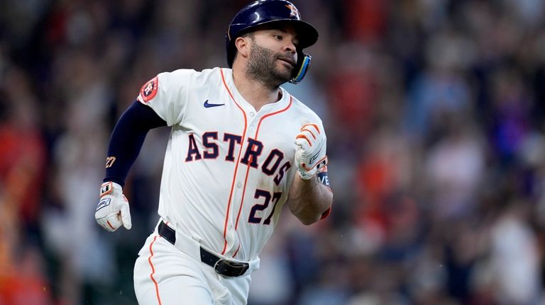 Houston Astros' Jose Altuve rounds the bases after hitting a...