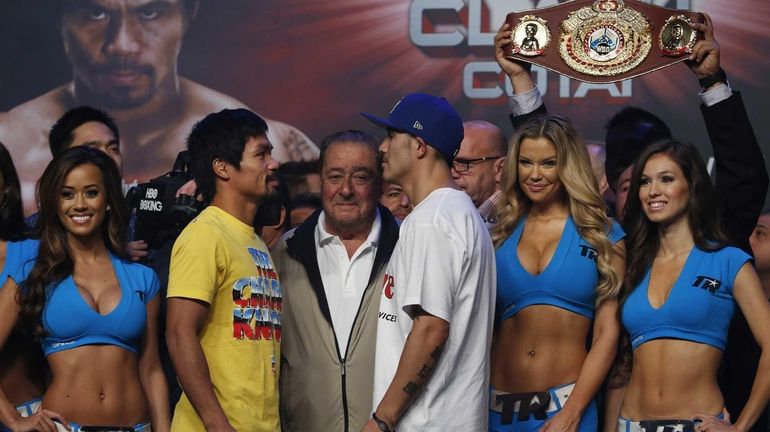 Filipino boxer Manny Pacquiao, center left, and Brandon Rios of...