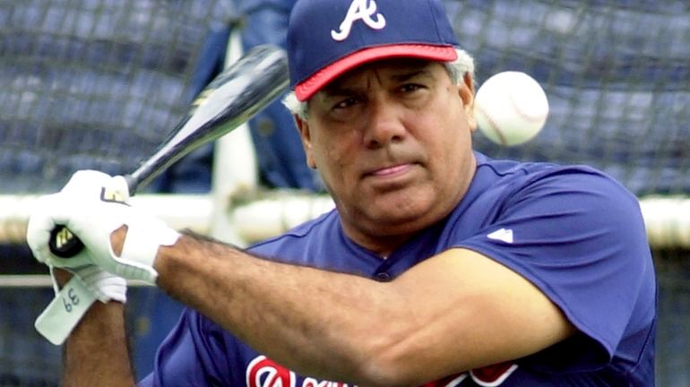 Atlanta Braves coach Pat Corrales hits ground balls during batting...