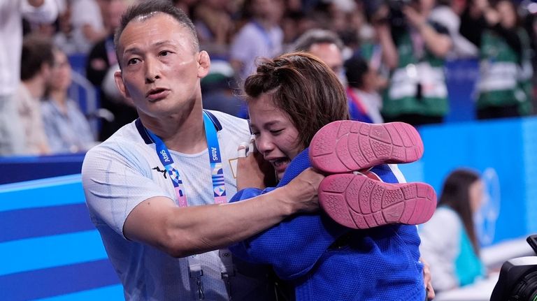 Japan's Uta Abe reacts after the women -52 kg elimination...