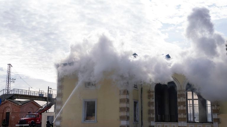 Firefighters put out the fire a railway station after Russians...