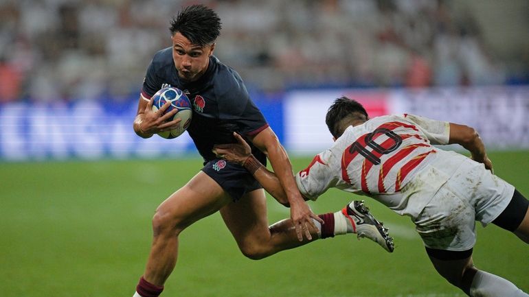 England's Marcus Smith tries to get past Japan's Rikiya Matsuda...