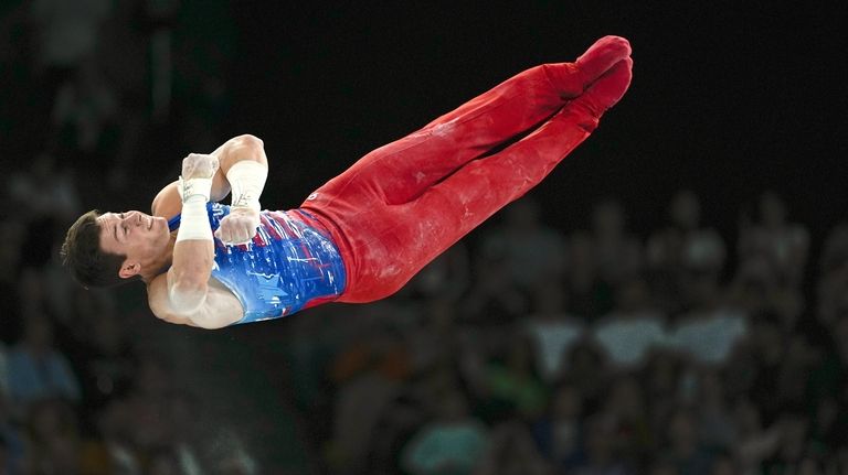 Brody Malone, of United States, competes on the horizontal bar...