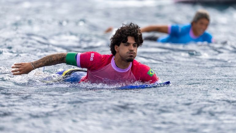 Brazil's Gabriel Medina paddles in the men's surfing third round...