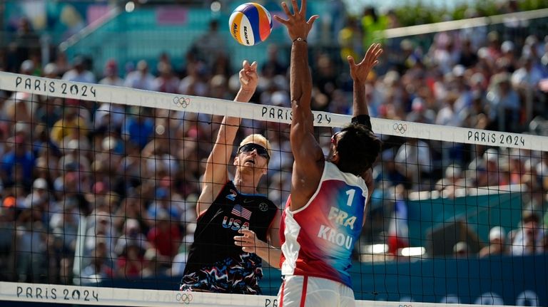 United States' Chase Budinger hits the ball by France's Youssef...