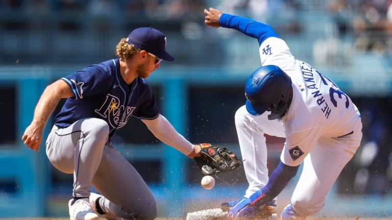 Los Angeles Dodgers' Teoscar Hernández, right, steals second ahead of...