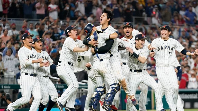 Japan player Shohei Ohtani (16) celebrates with his teammates after...