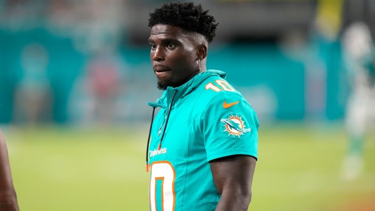 Miami Dolphins wide receiver Tyreek Hill watches from the sideline...