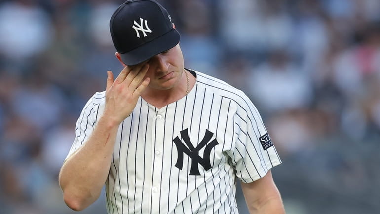 Yankees starting pitcher Clarke Schmidt (36) reacts during the third...