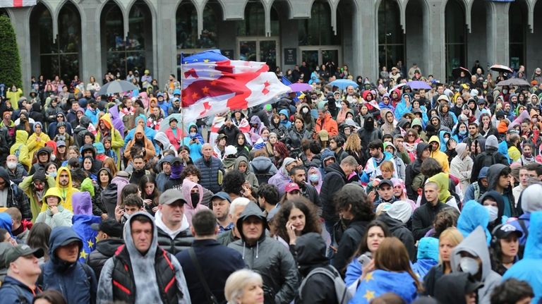 Demonstrators with Georgian national and EU flags gather during an...