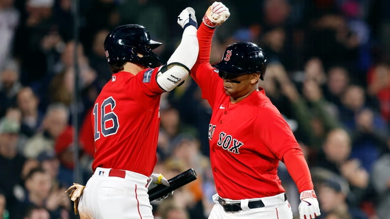 Boston Red Sox's Rafael Devers, right, celebrates after his two-run...