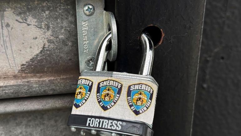 A New York City Sheriff's Department padlock secures Spark &...