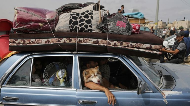 Palestinians fleeing from the southern Gaza city of Rafah during...