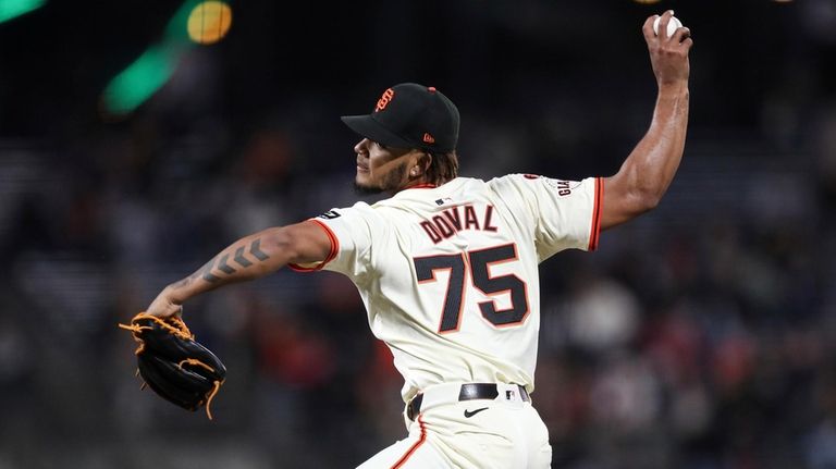 San Francisco Giants pitcher Camilo Doval throws to a Milwaukee...