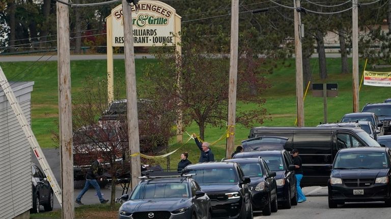 A body is wheeled out on a stretcher at Schemengees...