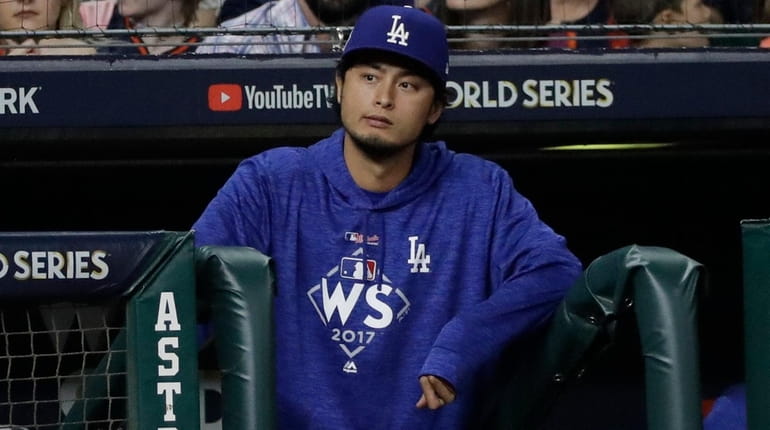 The Dodgers' Yu Darvish watches Game 4 of the World...