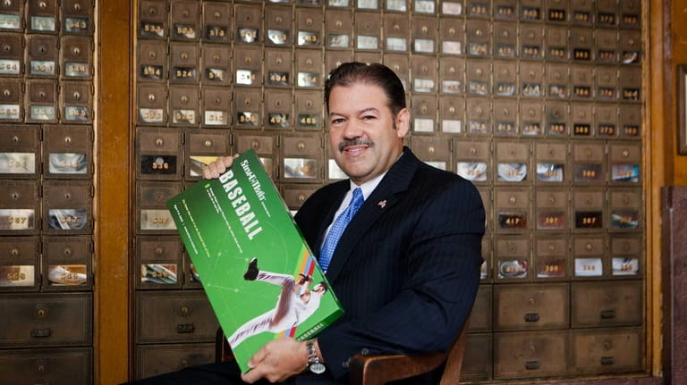 Dioenis D. Perez, Oyster Bay postmaster, with the game he...