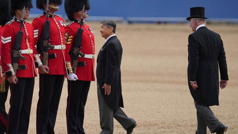 Japan's Emperor Naruhito, escorted by Britain's King Charles III inspect...