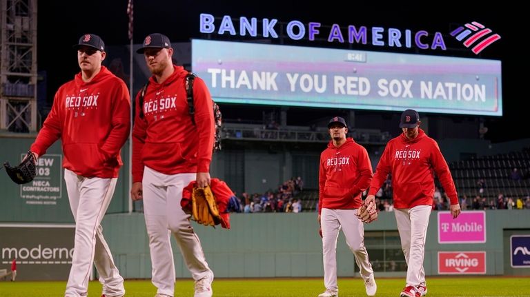 Boston Red Sox pitchers walk from the bullpen following the...