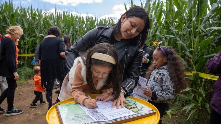 Camila Munoz, 3, and Jissell Munoz from Brooklyn work on...