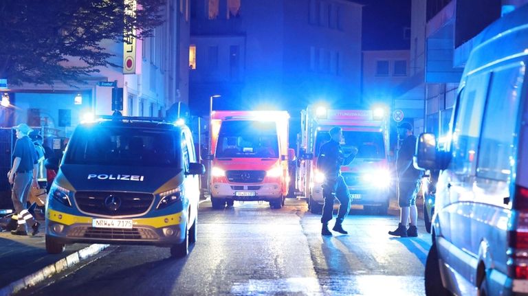 Police and ambulances near the scene where people were killed...