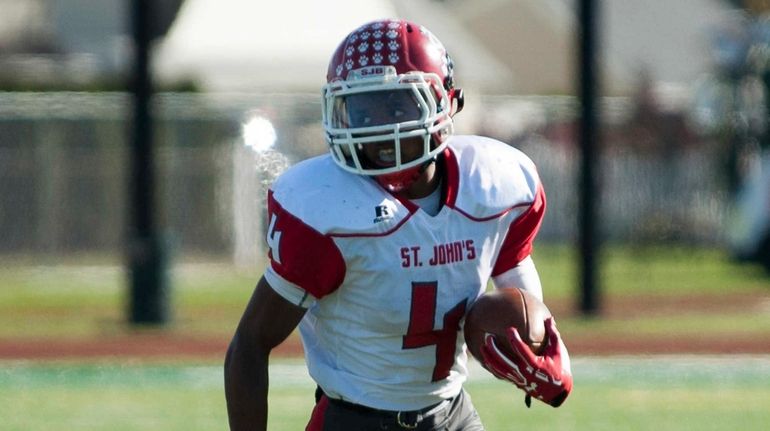 St. John the Baptist's Daniel Parker runs the ball during...