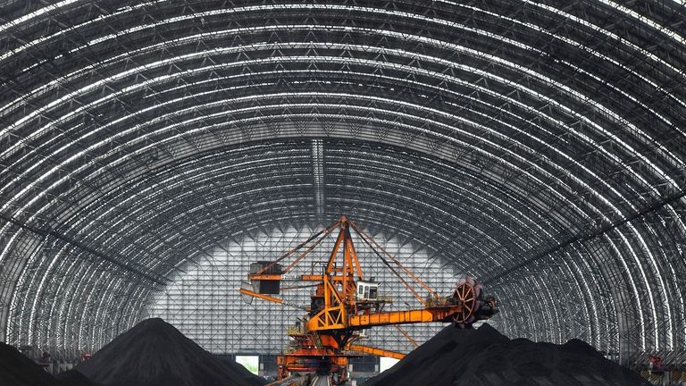 A machine is operated on the storage of coal at...