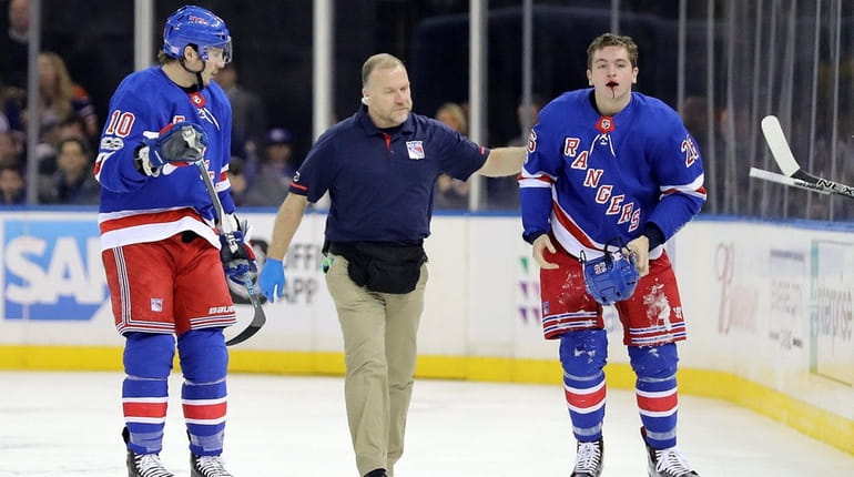 The Rangers' Jimmy Vesey leaves the ice after taking a...