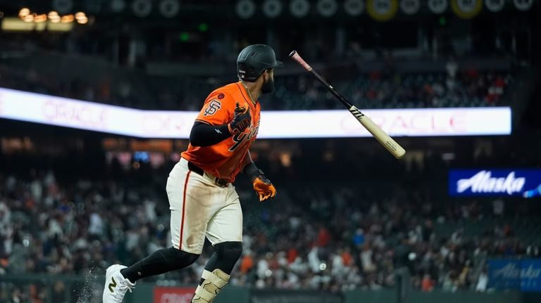 San Francisco Giants' Heliot Ramos flips his bat after hitting...